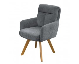 Dizajnové škandinávske otočné jedálenské kreslo Dover so ženilkovým poťahom v sivej farbe so zamatovým leskom s čalúneným opierkovým vankúšom s prešívaním v tvare T s hnedými šikmými nožičkami z bukového dreva