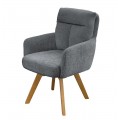 Dizajnové škandinávske otočné jedálenské kreslo Dover so ženilkovým poťahom v sivej farbe so zamatovým leskom s čalúneným opierkovým vankúšom s prešívaním v tvare T s hnedými šikmými nožičkami z bukového dreva