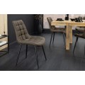 Dizajnová industriálna jedálenská stolička Moritz s prešívaným čalúnením v sivom odtieni taupe a čiernymi kovovými nohami 51 cm