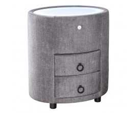 Art deco čalúnený sivý nočný stolík Aluro s poťahom zo zamatu s dvomi zásuvkami s bielou vrchnou doskou so zabudovaným LED podsvietením oválneho tvaru na nízkych čiernych nožičkách