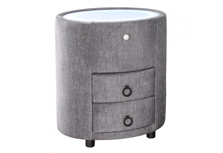 Art deco čalúnený sivý nočný stolík Aluro s poťahom zo zamatu s dvomi zásuvkami s bielou vrchnou doskou so zabudovaným LED podsvietením oválneho tvaru na nízkych čiernych nožičkách