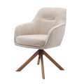 Dizajnová moderná jedálenská stolička Egon s čalúnenou otočnou sedacou časťou s poťahom s ľanovým dizajnom v svetlej béžovej farbe so štyrmi šikmými nohami z masívneho dubového dreva v prírodnej hnedej farbe