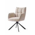 Moderná škandinávska krémová jedálenská stolička v odtieni ľanu s otočnou sedacou časťou so ženilkovým poťahom s prešívaním s obdĺžnikovým vzorom na opierke s bočnými opierkami na ruky s podstavou z kovu v čiernej farbe so štyrmi šikmými ramenami