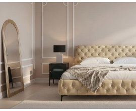 Modern&aacute; art deco zostava n&aacute;bytku do sp&aacute;lne Modern Barock s b&eacute;žovou zamatovou manželskou posteľou s diamantov&yacute;m pre&scaron;&iacute;van&iacute;m so zlat&yacute;m obl&uacute;kovit&yacute;m zrkadlom a čiernym kovov&yacute;m nočn&yacute;m stol&iacute;kom s rebrovan&yacute;m sklom a mramorovou lampou s bielou podstavou