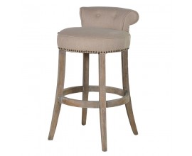Luxusná vintage barová stolička Clayton v okrúhlom tvare s prešívaným poťahom v béžovej farbe s gombíkmi s nitmi s nožičkami z dubového dreva v hnedej farbe s bielou patinou s čalúnením