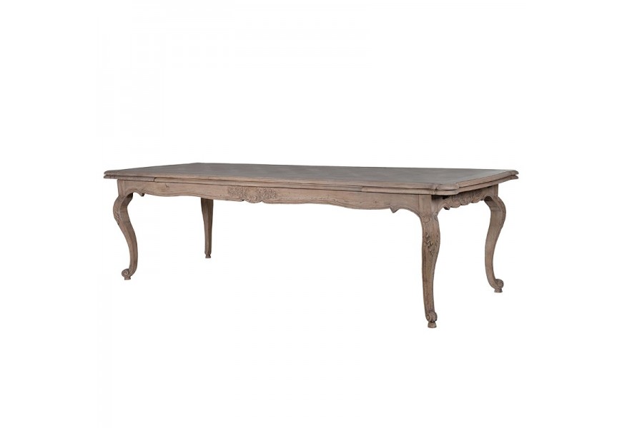 Provensálsky rozkladací jedálenský stôl Nature z masívneho akáciového dreva v béžovej farbe s vrchnou doskou obdĺžnikového tvaru s dekoratívnym geometrickým vzorom s florálnymi ornamentmi so sústruženými nožickami