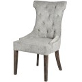 Luxusná sivá čalúnená jedálenská stolička Tratcher s drevenými nohami a strieborným klopadlom v Chesterfield štýle