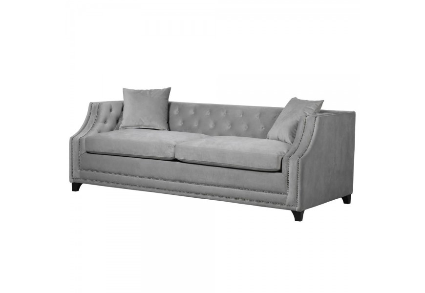 Sivá rozkladacia sedačka s prešívaným zamatovým čalúnením na čiernych nožičkách