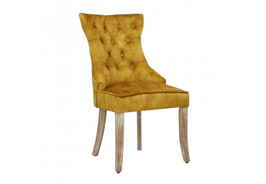 Dizajnov&aacute; chesterfield jed&aacute;lensk&aacute; stolička Torino horčicovožltej farby zo zamatu s dreven&yacute;mi nohami a strieborn&yacute;m klopadlom 96cm