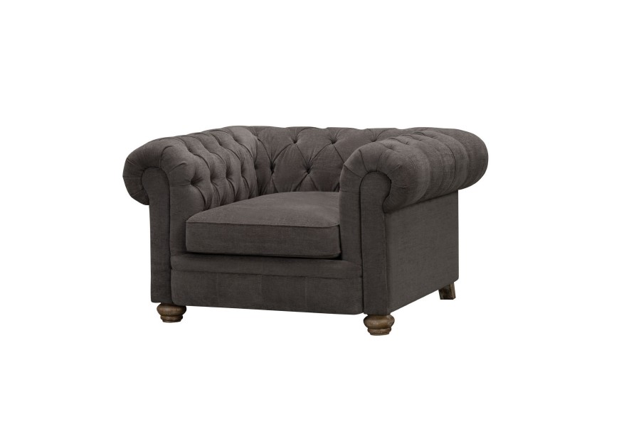 Exkluzívne kreslo Veera s Chesterfield textilným poťahom v tmavo sivom prevedení so štýlovými vintage hnedými nožičkami