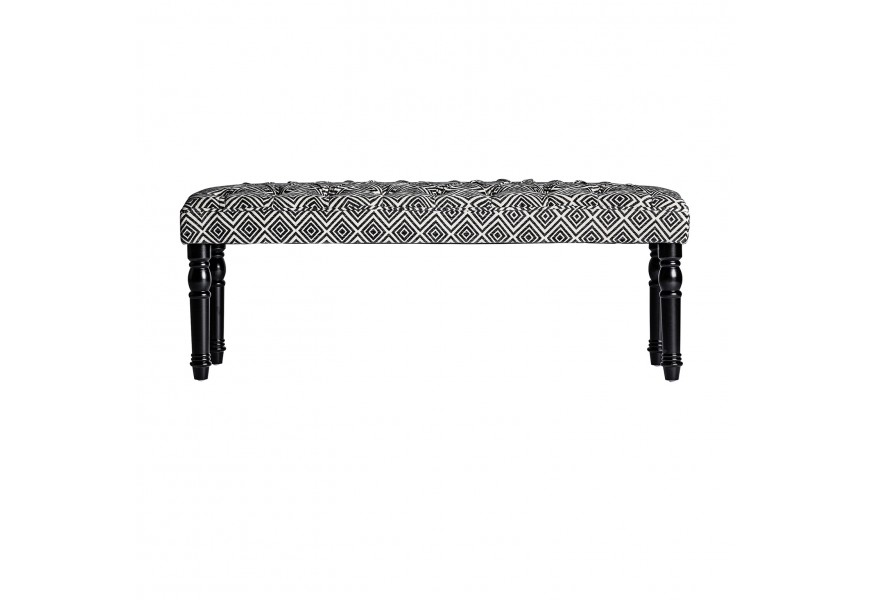 Dizajnový retro taburet Avers s čierno bielym textilným Chesterfield čalúnením s drevenými nožičkami