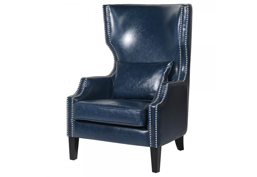 Čalúnené kožené vintage kreslo ušiak Blues v džínsovo modrom vyhotovení na drevených čiernych nožičkách s ozdobnými nitmi