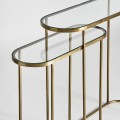 Art-deco set oválnych konzolových stolíkov Amuny so sklenenou doskou a kovovou konštrukciou v zlatej farbe 91cm