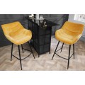 Industriálna dizajnová barová stolička Kotor v žltom prevedení so zamatovým poťahom a čiernou kovovou konštrukciou 105cm