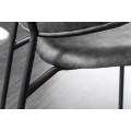 Moderná dizajnová jedálenská stolička Mildred so sivým zamatovým čalúnením a čiernymi nohami z kovu 83cm