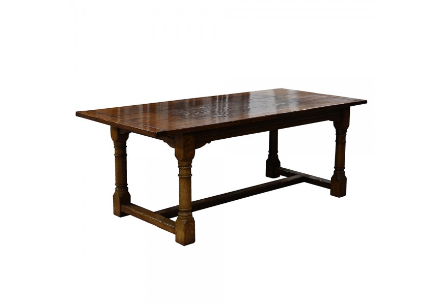 Rustikálny jedálenský stôl Terrel z dubového masívu na vyrezávaných nožičkách v tmavohnedej farbe v tvare obdĺžnika
