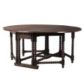 Drevený okrúhly jedálenský stôl Azrael tmavohnedej farby so sklápateľnou doskou a praktickými zásuvkami
