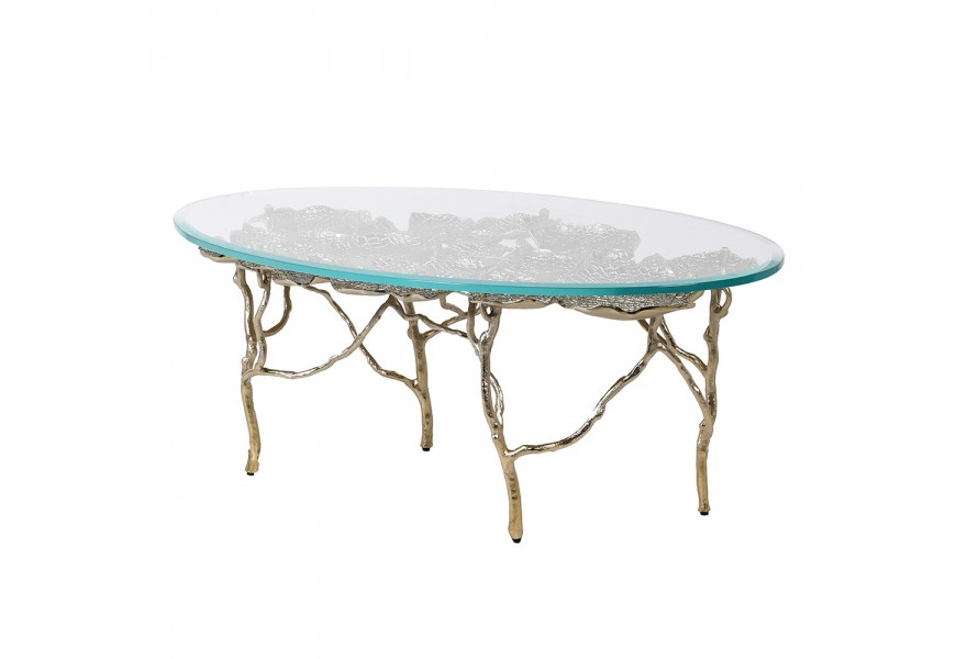 Art deco dizajnový oválny jedálenský stôl Lilypad zlatej farby s priehľadnou sklenenou doskou