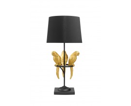 Dizajnová glamour stolová lampa Macaw s čiernou konštrukciou a okrúhlym tienidlom s dekoráciou troch papagájov v zlatej farbe na obruči
