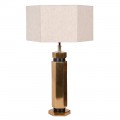 Dizajnová art deco stolná lampa Anasa s kovovou podstavou v lesklej zlatej farbe šesťuholníkového tvaru a textilným ľanovým tienidlom v svetlej béžovej farbe v tvare šesťuholníka
