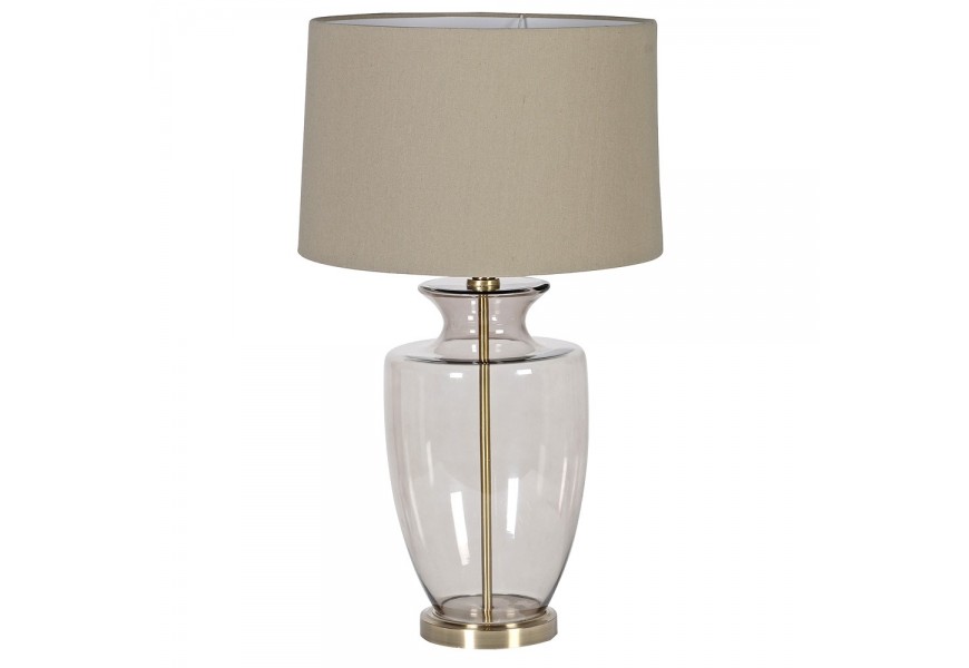 Sklenená stolná lampa Luminara v glamour štýle s okrúhlou starozlatou podstavou, dymovou sklenenou nohou v svetlohnedom odtieni a ľanovým tienidlom v teplom béžovom odtieni