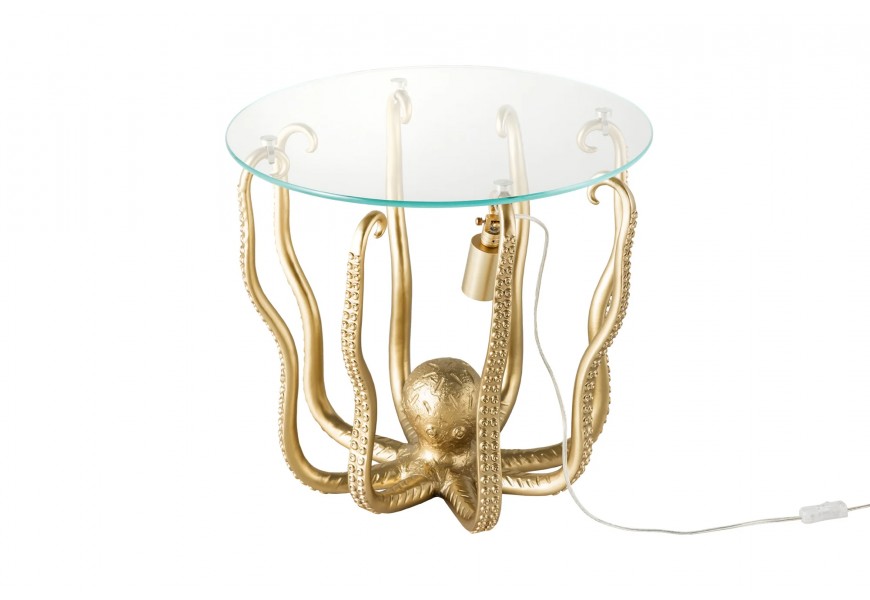 Štýlový art deco príručný stolík Tierra Glam s podstavou v podobe chobotnice v zlatej farbe s okrúhlou sklenenou doskou s glamour nádychom