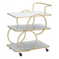 Dizajnový art deco kovový servírovací vozík Palais s geometrickou zlatou konštrukciou s troma obdĺžnikovými bielymi policami s bezpečnostným sklom s ergonomickou úchytkou so štyrmi nožičkami na kolieskach s brzdami