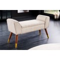 Dizajnová art deco lavica Karen s béžovým čalúnením a hnedými drevenými nohami so zlatými detailmi 90 cm