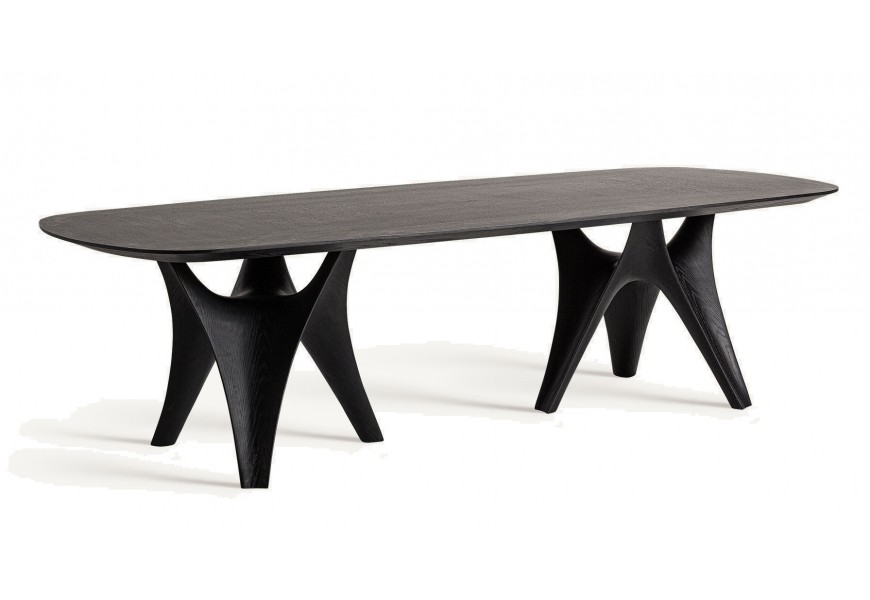 Elegantný art deco jedálenský stôl Alessio s oválnou čiernou doskou z dubovej dyhy a podopretý dvoma sochársky tvarovanými podnožami zo sklolaminátu
