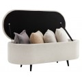 Dizajnová oválna lavica s úložným priestorom, čalúnená krémovou bouclé látkou s jemnou textúrou, doplnená čiernymi kovovými nožičkami, ideálna do moderných, škandinávskych alebo glamour interiérov
