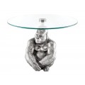 Art deco okrúhly príručný stolík Tierra Glam so striebornou kovovou podstavou v podobe gorily a sklenenou doskou 60 cm