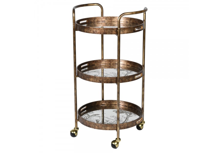 Industriálny kovový vozík Bronzia v bronzovej farbe s tromi okrúhlymi poličkami so zrkadlovou doskou s prírodným motívom stromov a vtákov na kolieskach
