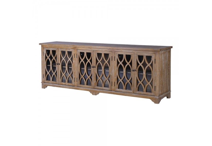 Koloniálny príborník Portalis z masívneho dreva v hnedej farbe s jemnou bielou patinou a ornamentálnymi sklenenými dvomi dvierkami