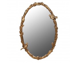 Dizajnové vintage závesné zrkadlo Forestia oválneho tvaru s rámom v zlatej farbe zo spletených konárov s listami a sediacimi vtáčikmi