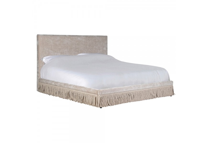 Luxusná dizajnová nadrozmerná manželská posteľ Trist potiahnutá textíliou v béžovej farbe s obdĺžnikovým čelom s dekoratívnymi strapcami